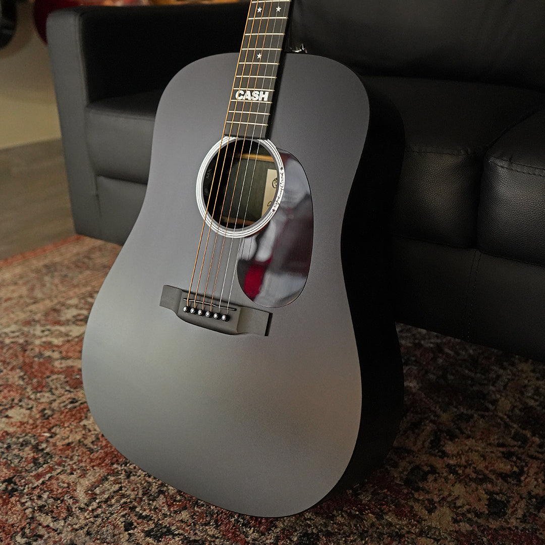 Dressed_in_Jett_Black_this_Martin_DX_Johnny_Cash_resonates_with_the_spirit_of_the_Man_in_Black_This_model_comes_with_Fishman_MX_electronics_and_a_soft_gig_bag_embroidered_with_the_CAS.webp
